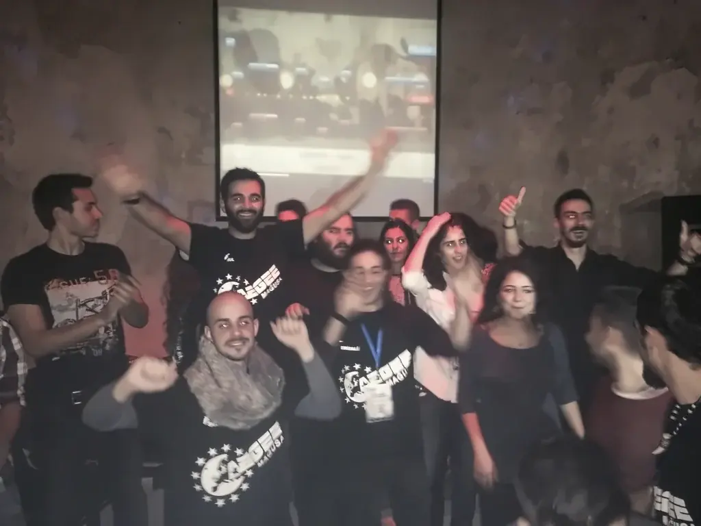 Students singing and dancing in front of the lyrics screen at the Demolay Church, Famagusta