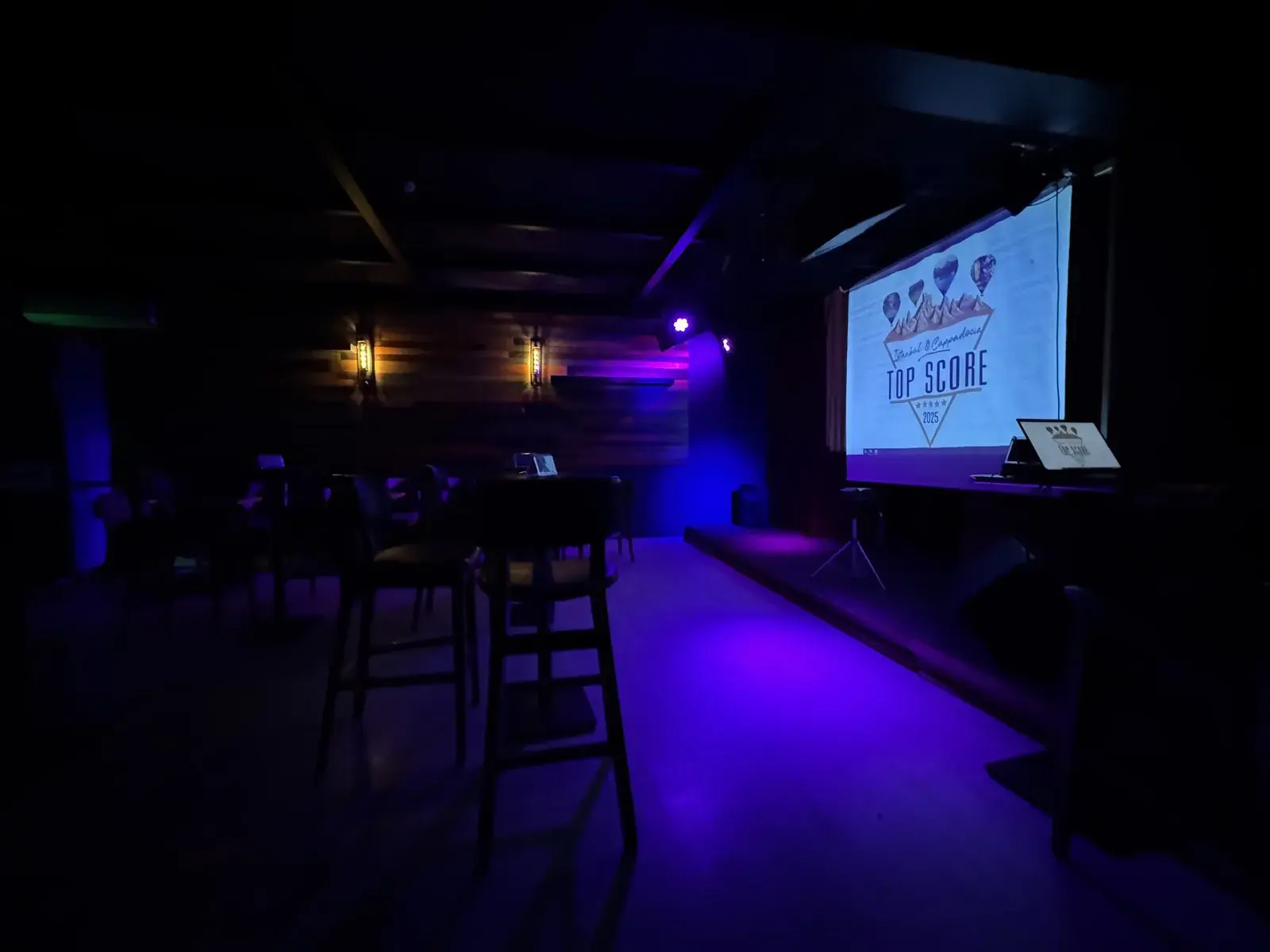 An event room set up for karaoke, with the screen ready before guests arrive