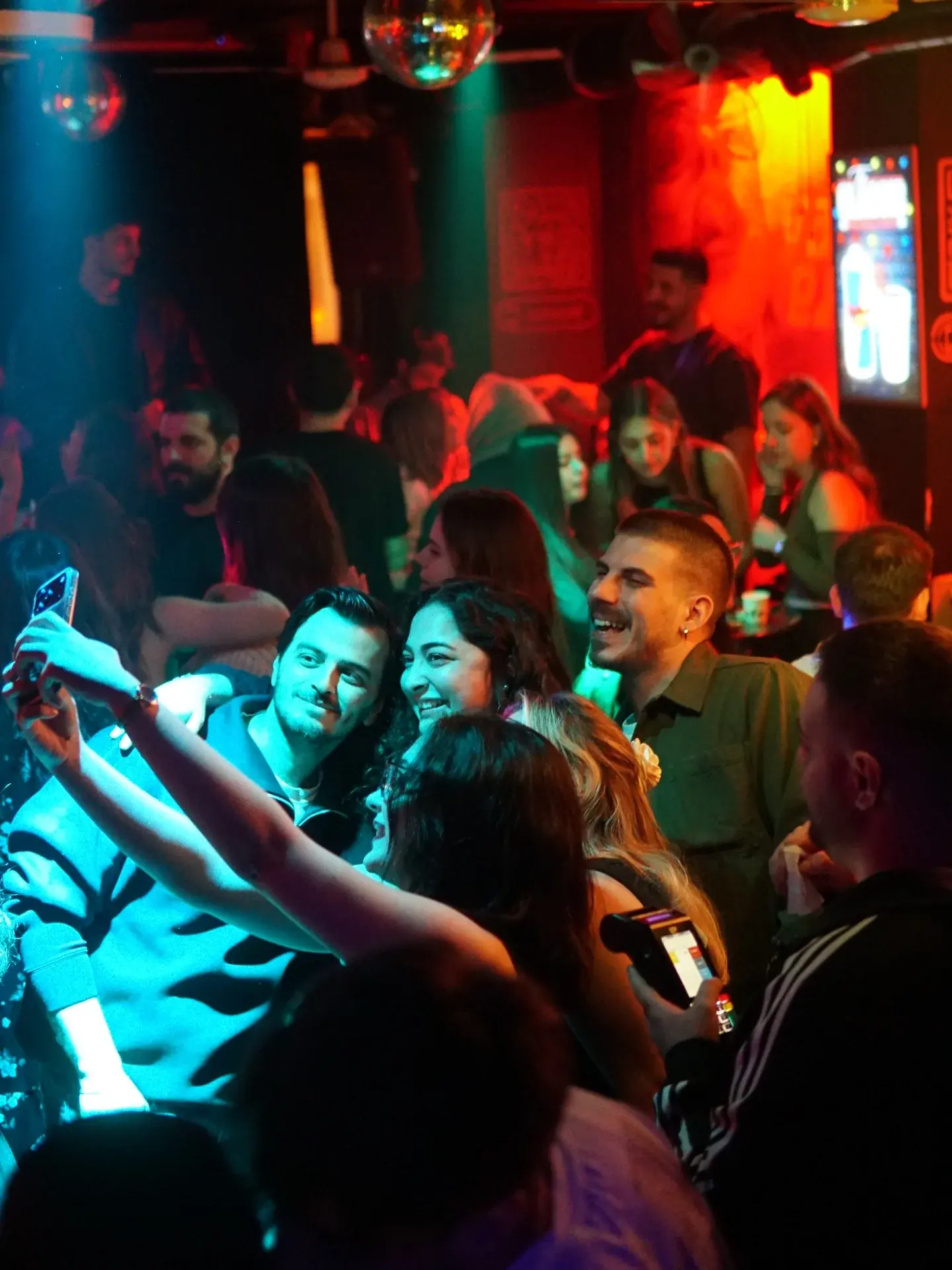 Friends taking a selfie together at a karaoke night
